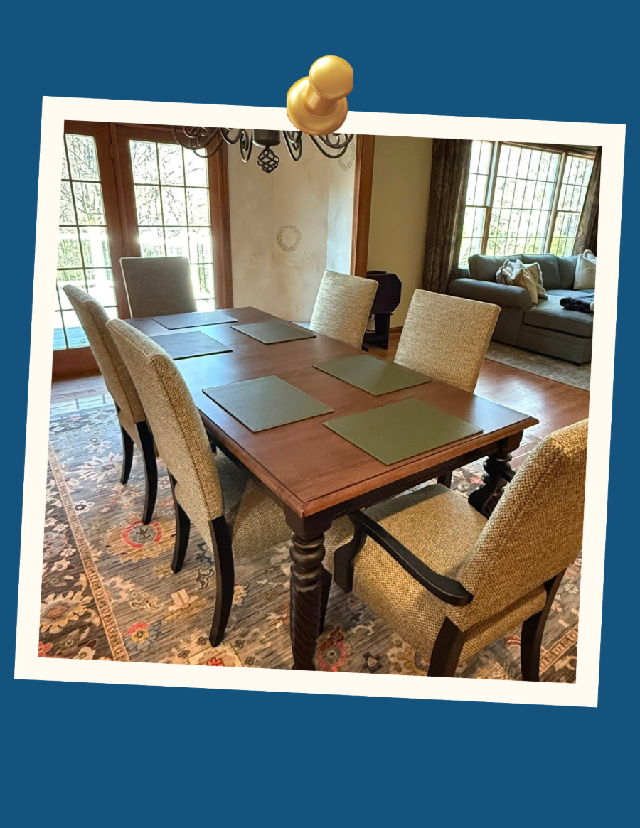 Dining table with woven chairs in a bright living room, shown in a framed snapshot style