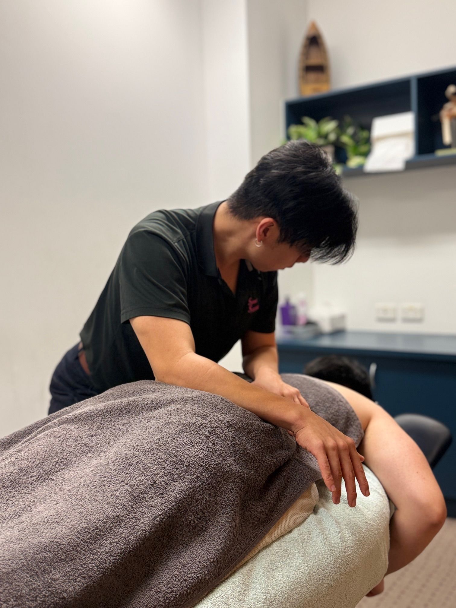 Man Giving a Massage to a Person on a Massage Table  — Spinal Symmetry In Seaforth, NSW