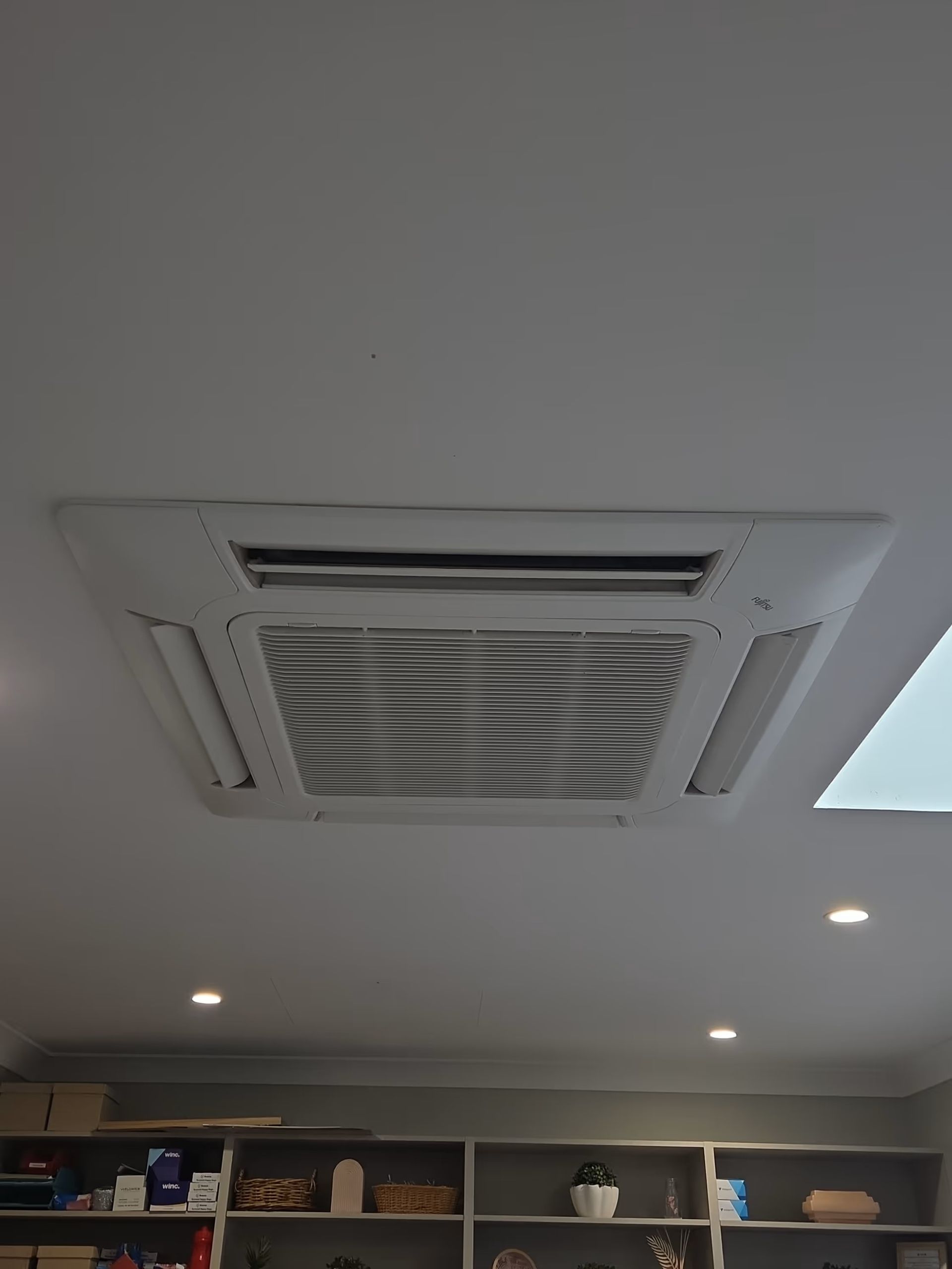 White industrial ceiling with exposed ducts and beams in a large mechanical space White industrial ceiling with exposed ducts and beams in a large mechanical space