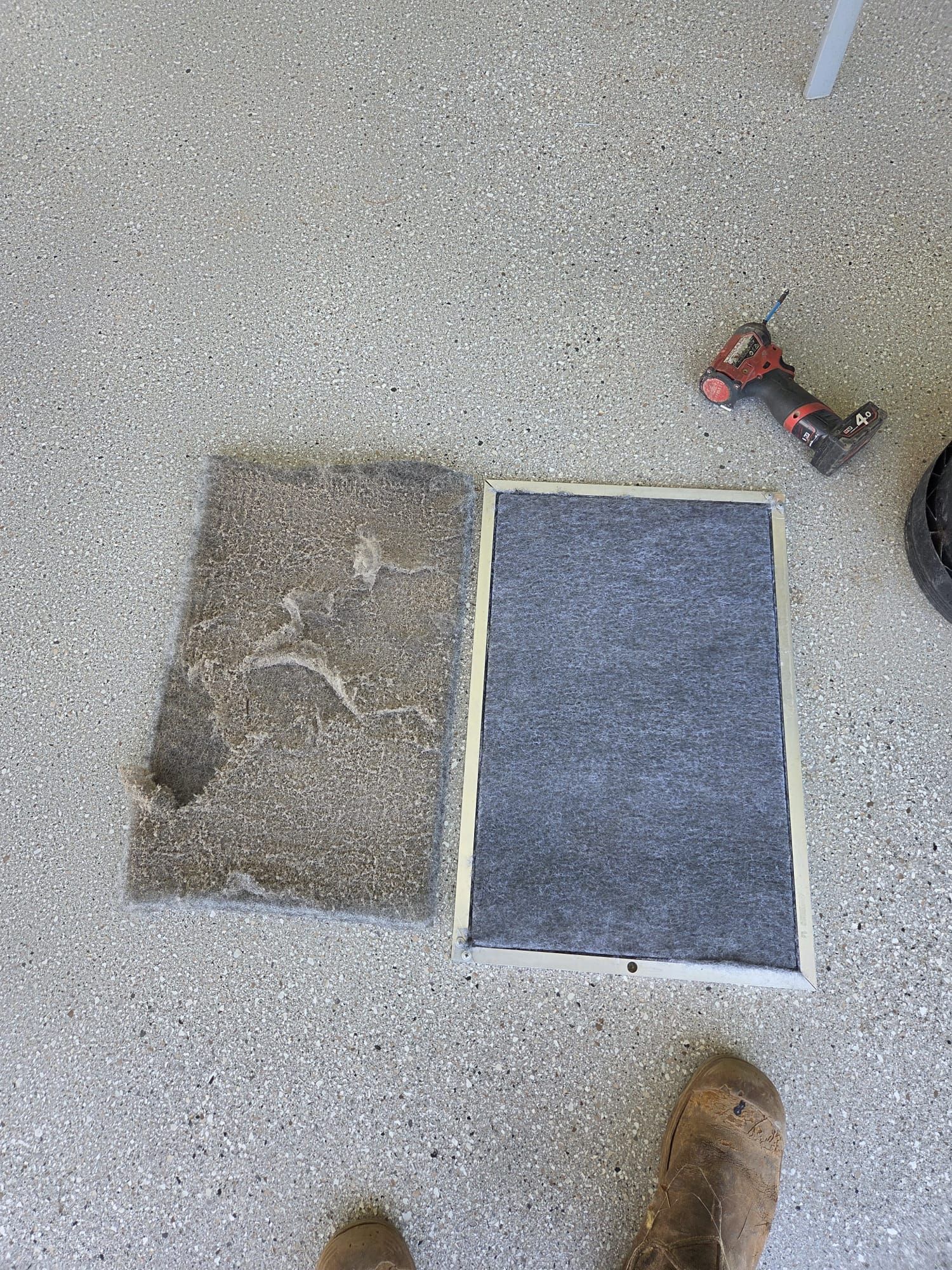 Hand vacuum cleaning a dusty wall-mounted air conditioner filter in a room Hand vacuum cleaning a dusty wall-mounted air conditioner filter in a room