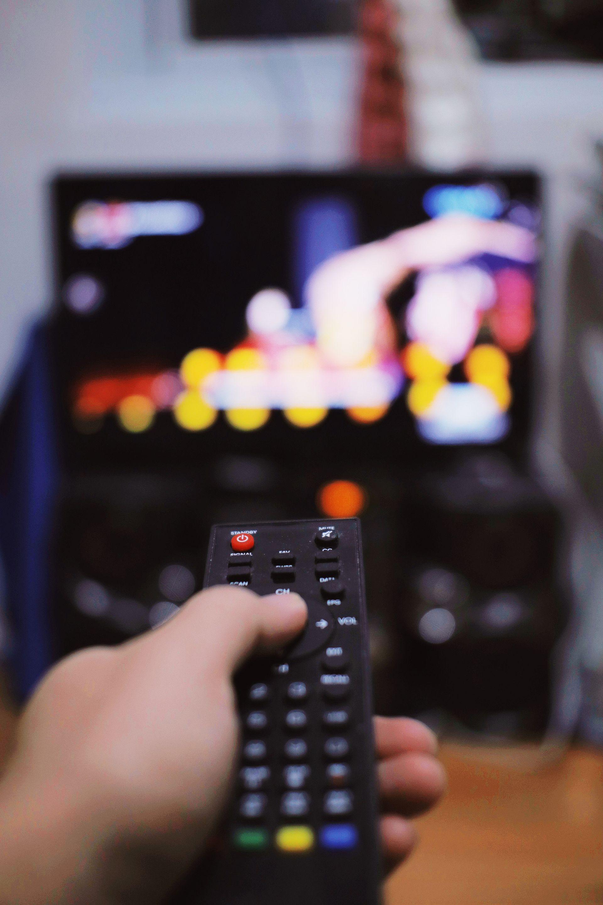 anonymous person with tv remote