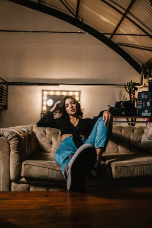 woman sitting on brown sofa