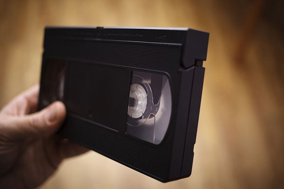 Person Holding Video Cassette Tape