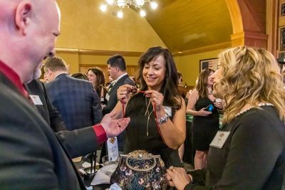 Corporate magic entertainer Matt Redlaw performing close-up magic for three people