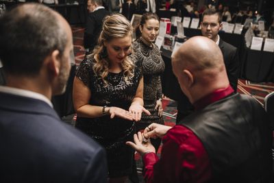 Corporate magic entertainer Matt Redlaw performing close-up magic for four people