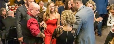 Corporate magic entertainer Matt Redlaw performing close-up magic for four people