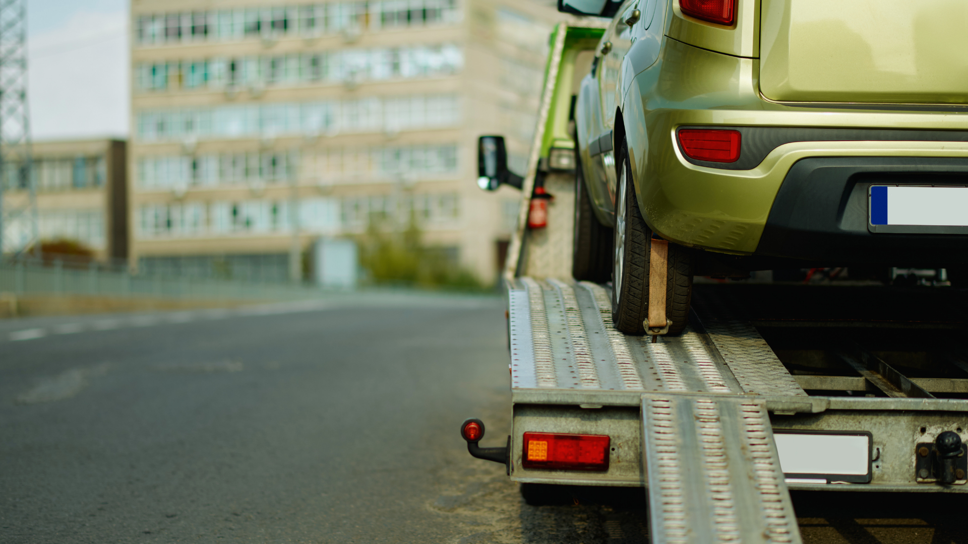 Vehicle being loaded onto a flatbed tow truck