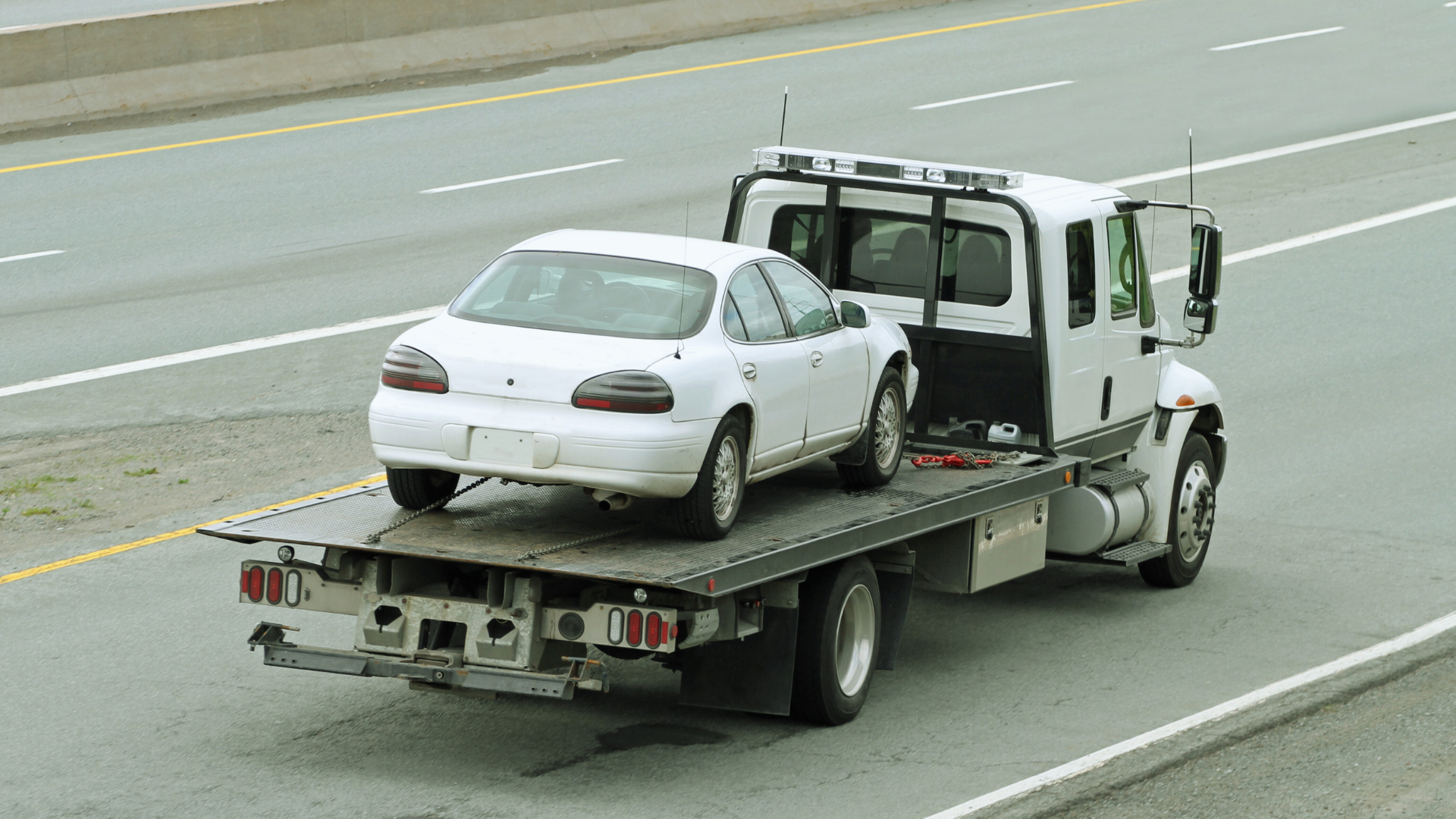Heavy-duty towing truck lifting a disabled vehicle