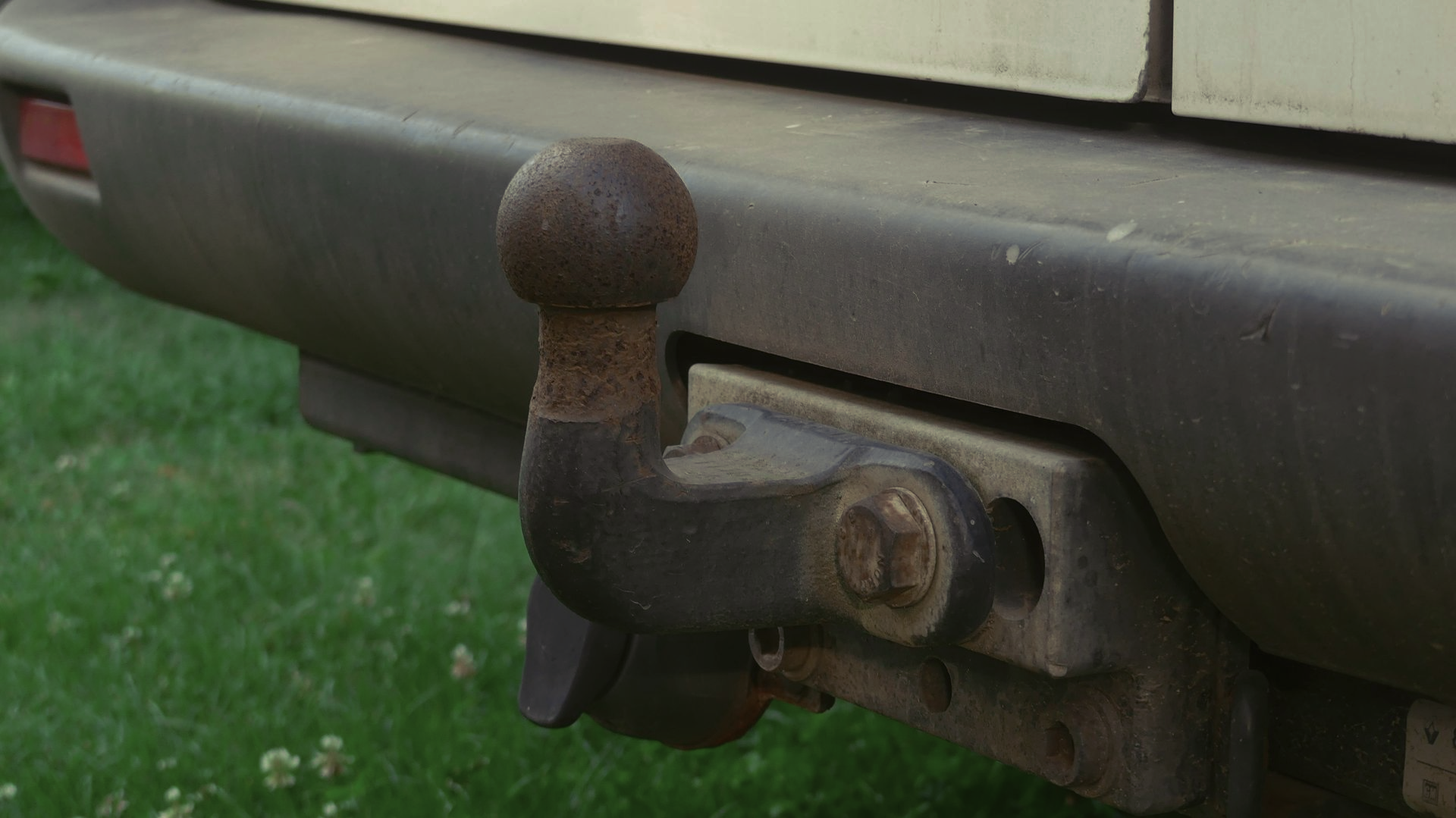 Technician connecting tow cables to a car