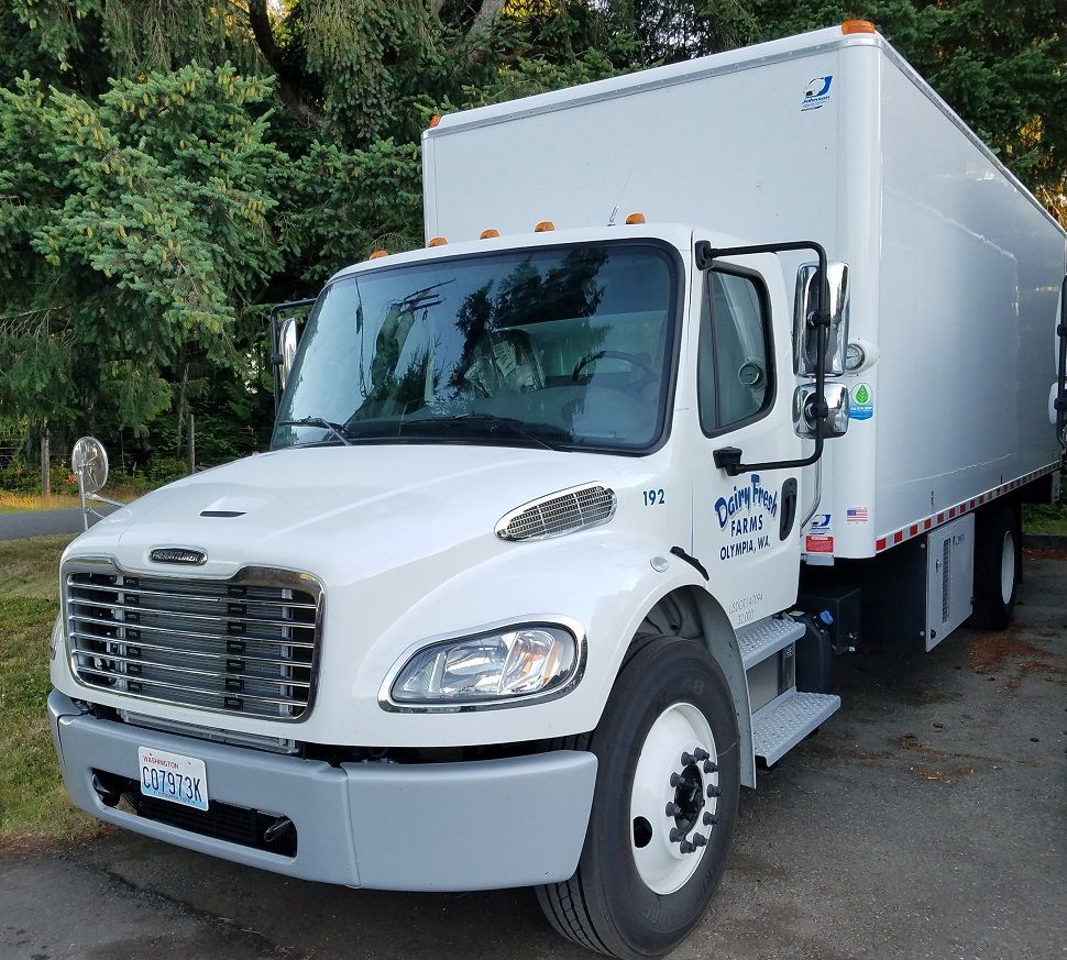 A white truck is parked on the side of the road