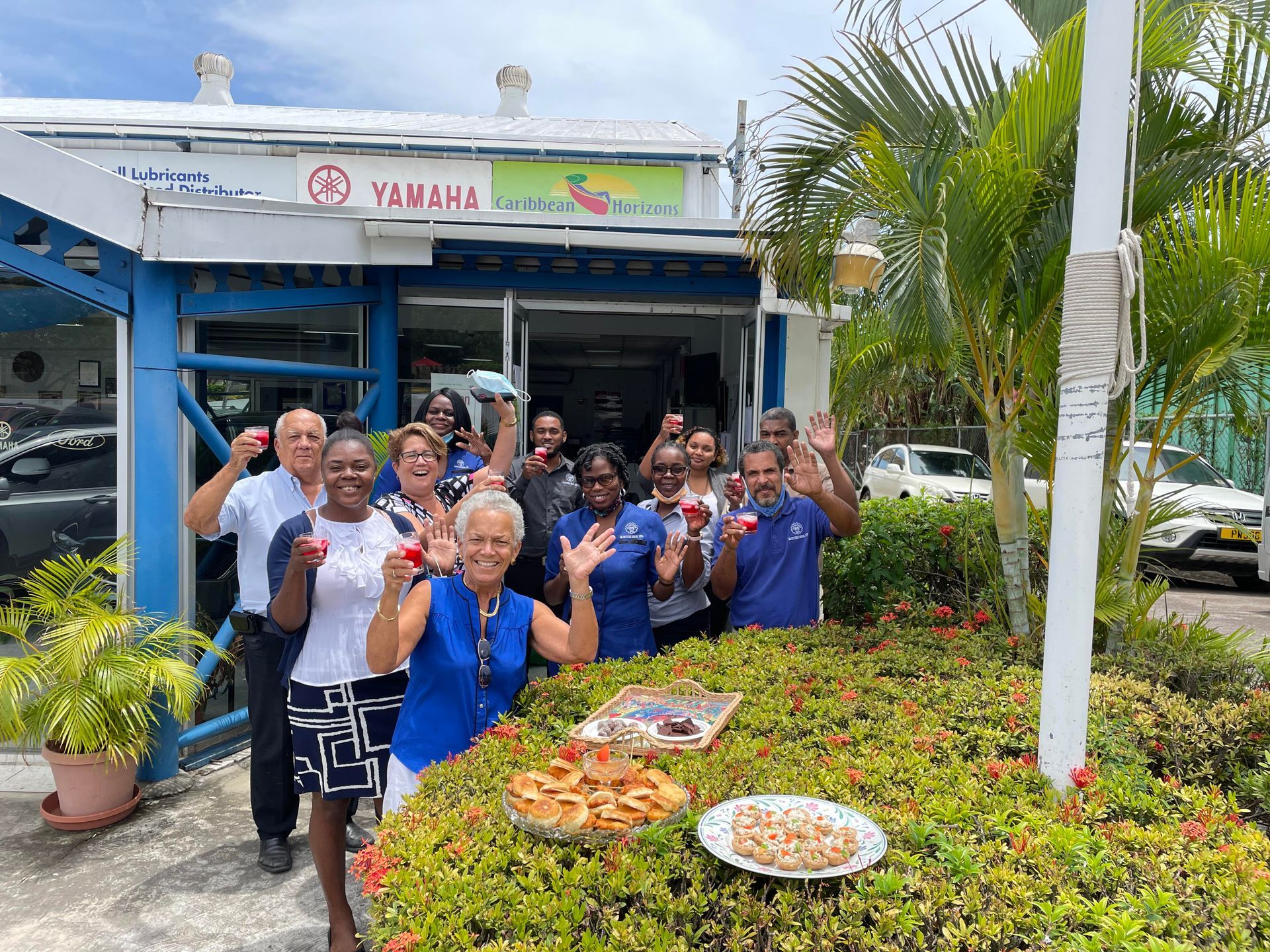 A group of people are posing for a picture while holding a drink