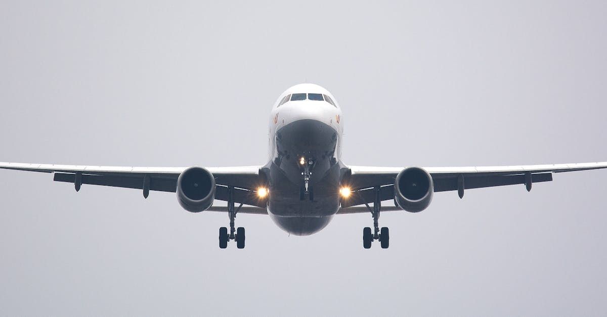 A large passenger jet is flying through a cloudy sky.