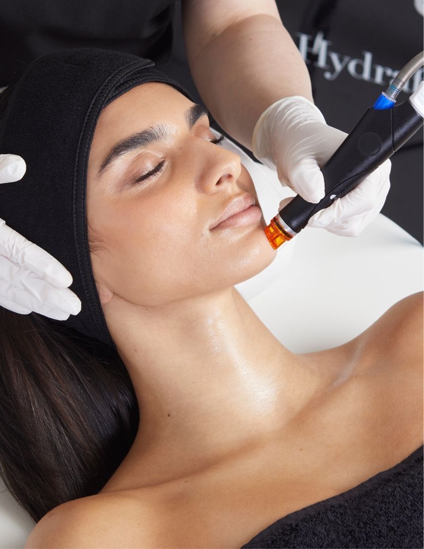 Woman Receiving a Facial Treatment With a Device Near Her Face, Eyes Closed — Eternal Radiance in Strathmore, VIC