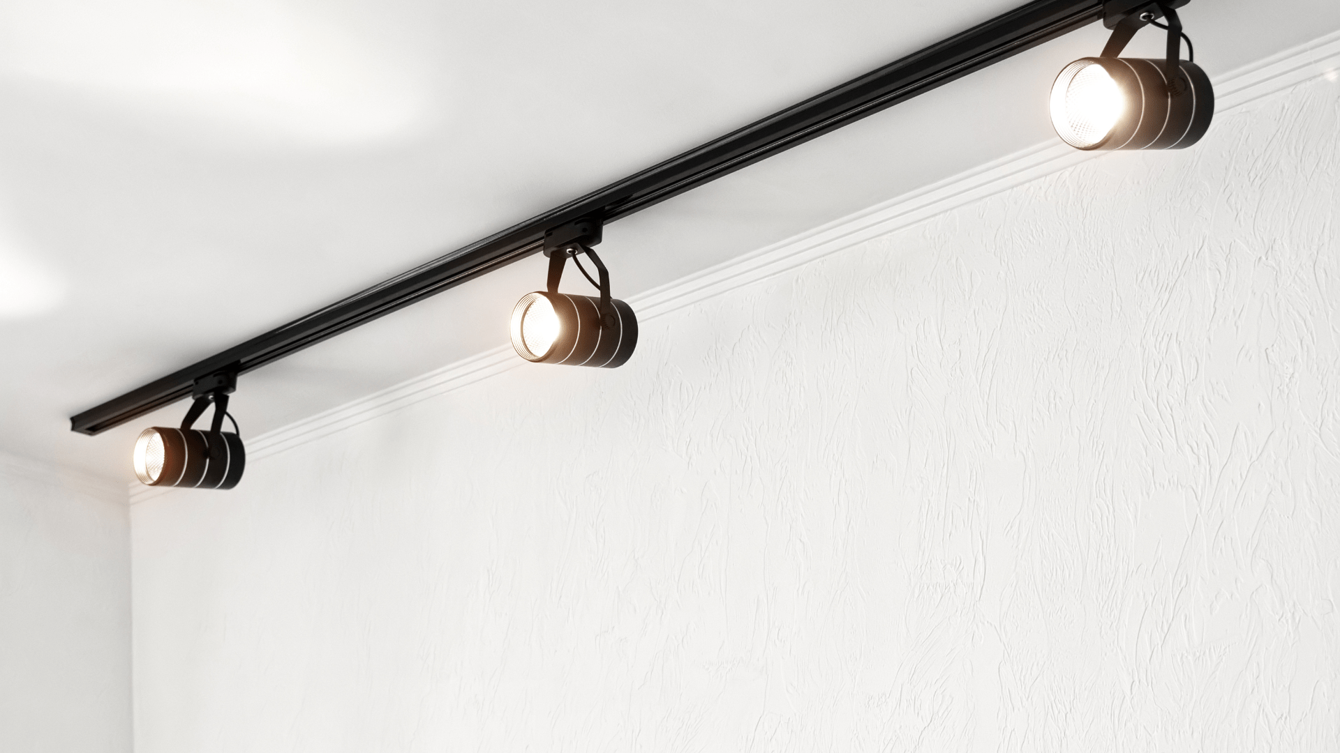 A row of spotlights are hanging from the ceiling of a room.