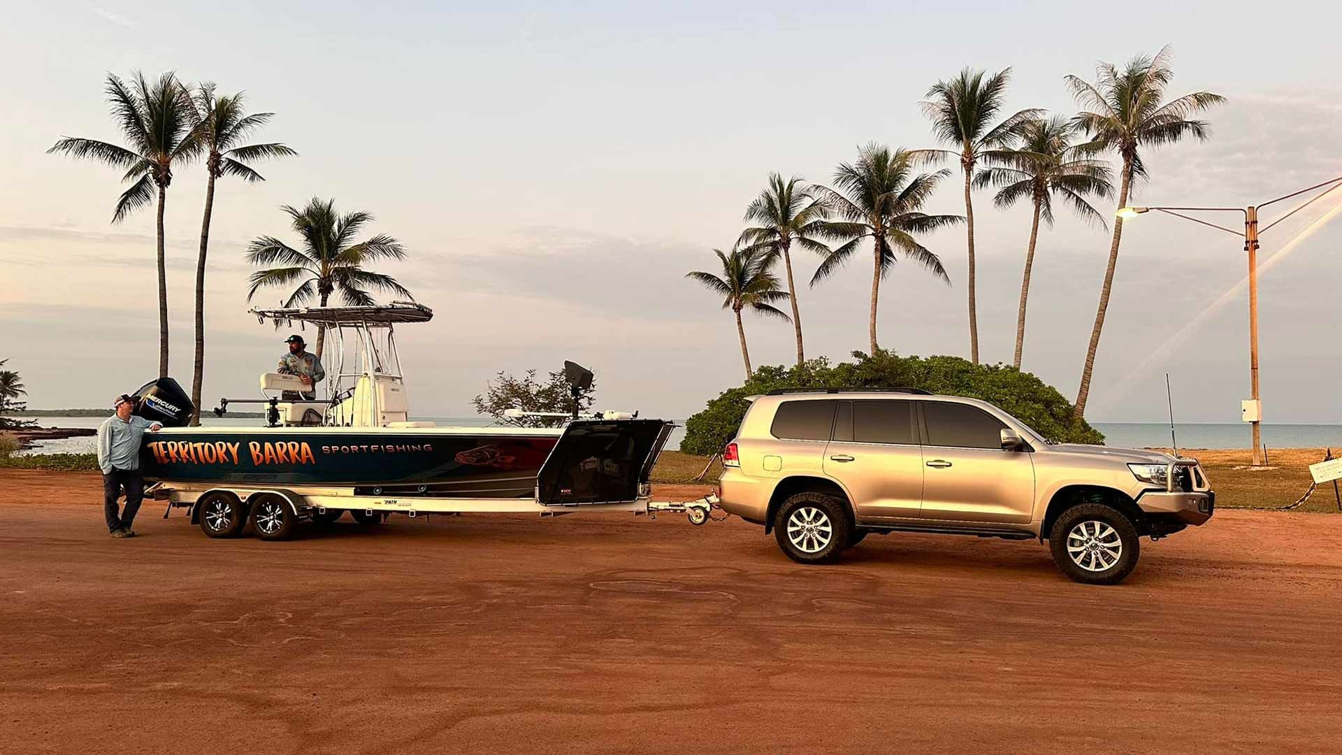 A Car Is Towing A Boat On A Trailer — Territory Barra Sportfishing In Zuccoli, NT