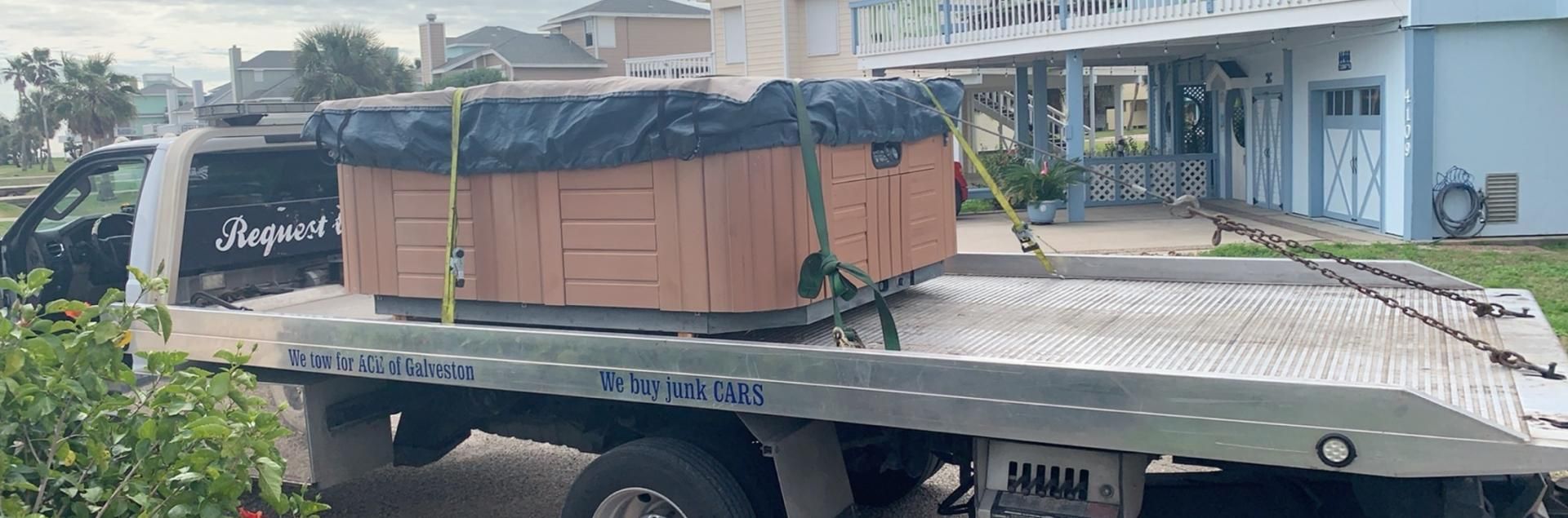 truck hauling a hot tub