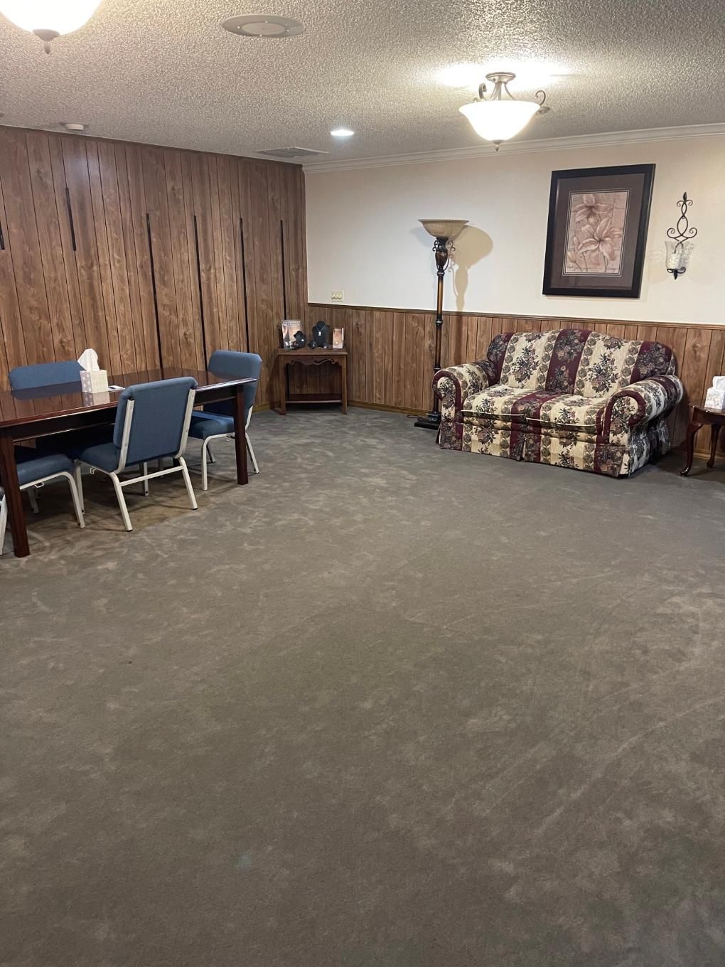 Qualls Funeral Home Arrangement and Family room with view of couch and chairs in Cave City, AR