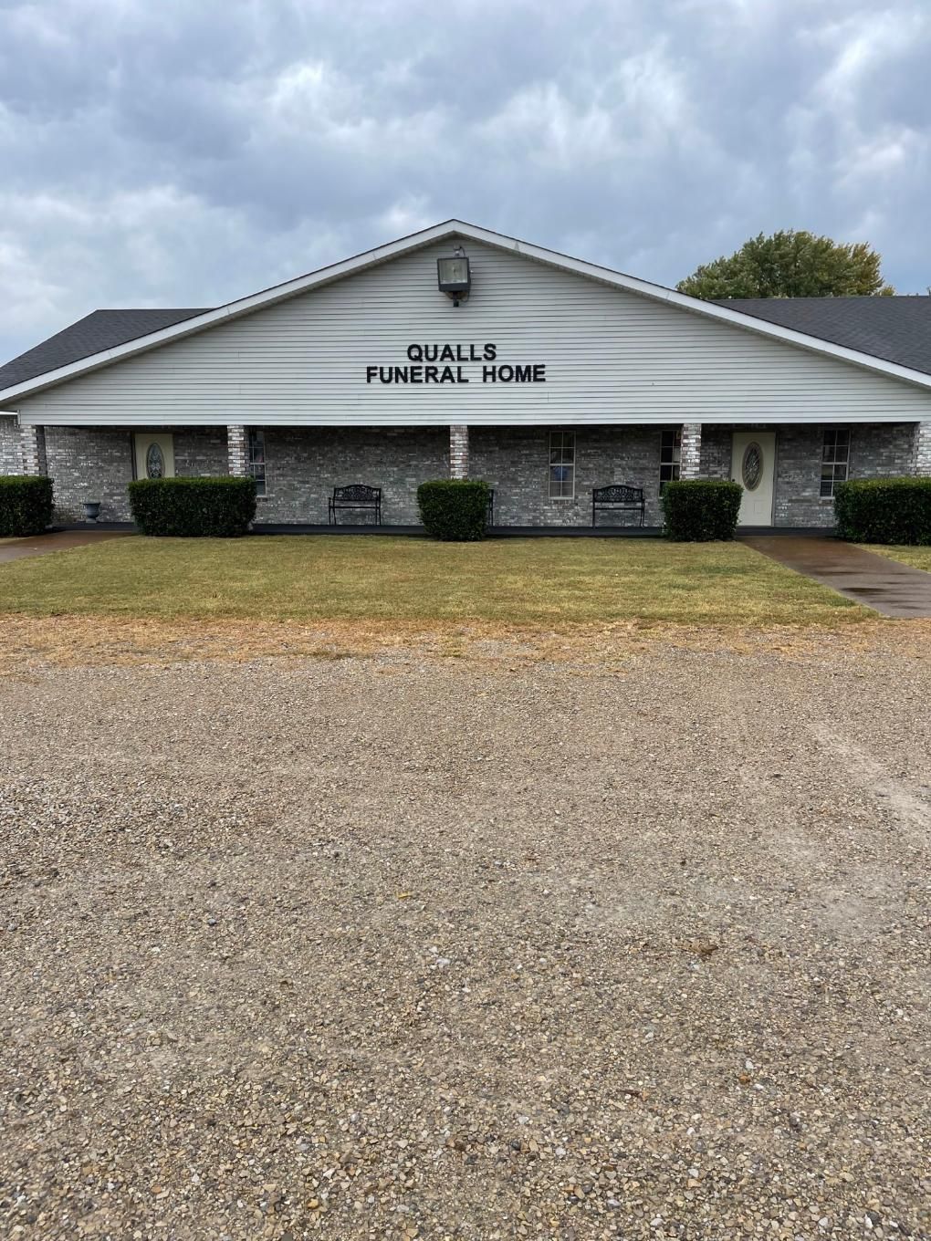 Qualls Funeral Home Parking log with front view of building in Cave City, AR