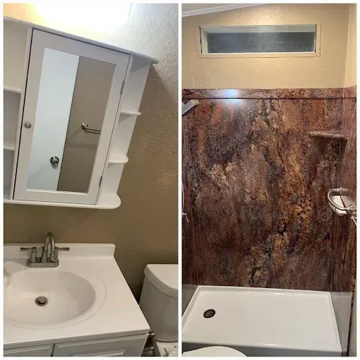 A side-by-side view of a bathroom vanity with a white sink and mirror, and a shower with a faux-marble wall surround.