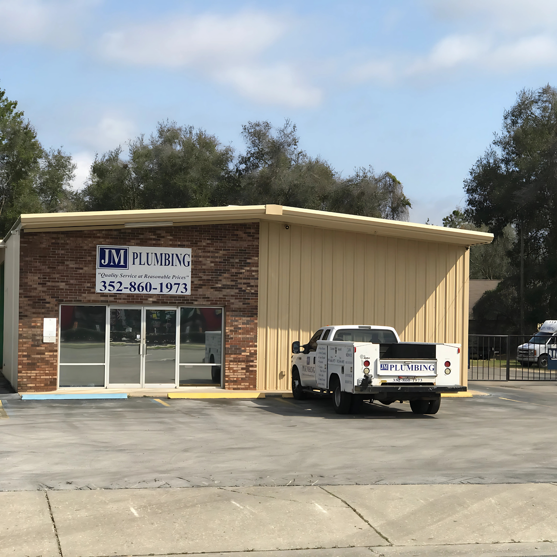 JM Plumbing Inc | a truck is parked in front of a building that says jm plumbing