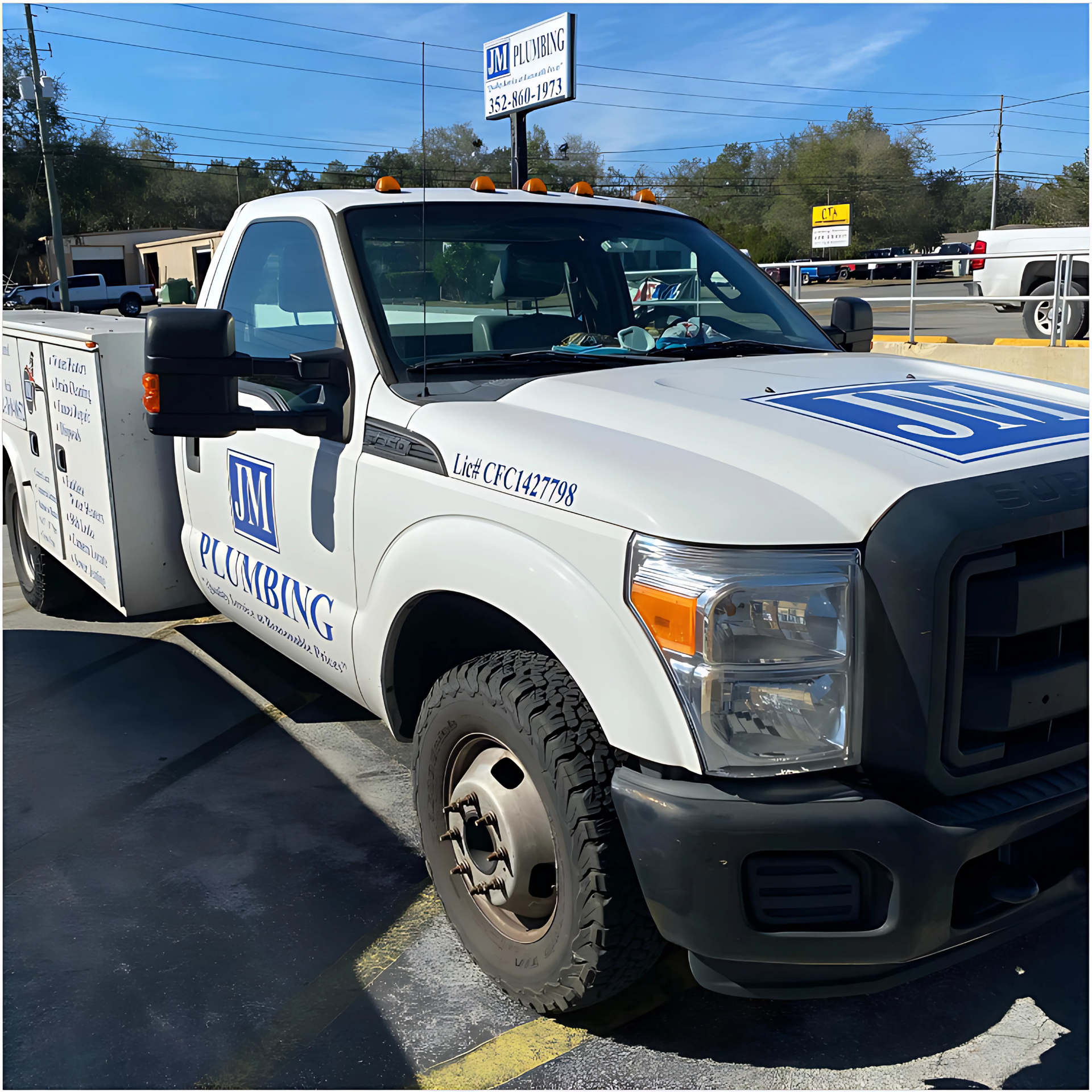 JM Plumbing Inc | a white plumbing truck is parked in a parking lot