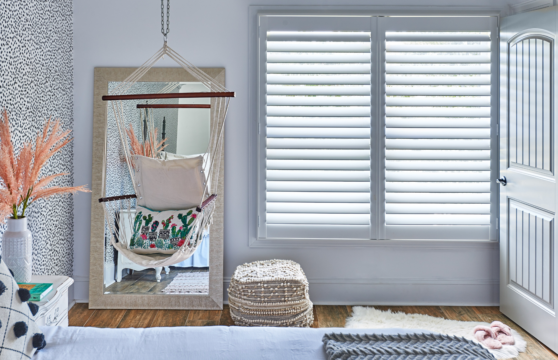 Artisan wood shutters with hidden tilt feature with a double panel configuration in a teen's bedroom