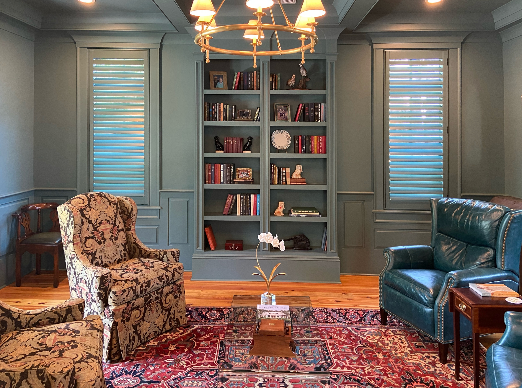 Custom painted green wood shutters in a traditional library