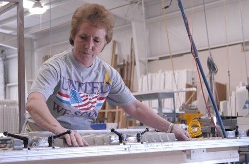 Woman manufacturing plantation shutters