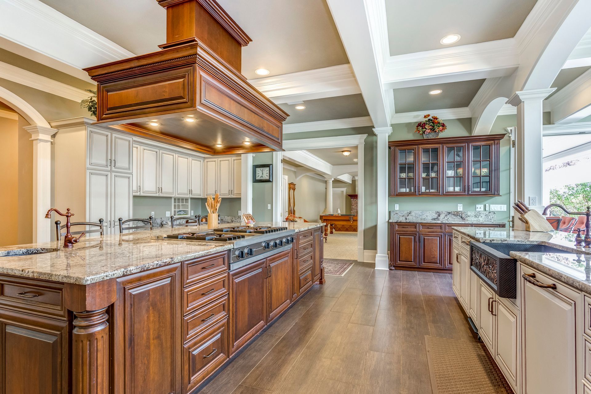 Modern kitchen with wood cabinets, marble counters, stainless appliances, island, and pool table. Modern kitchen with wood cabinets, marble counters, stainless appliances, island, and pool table.