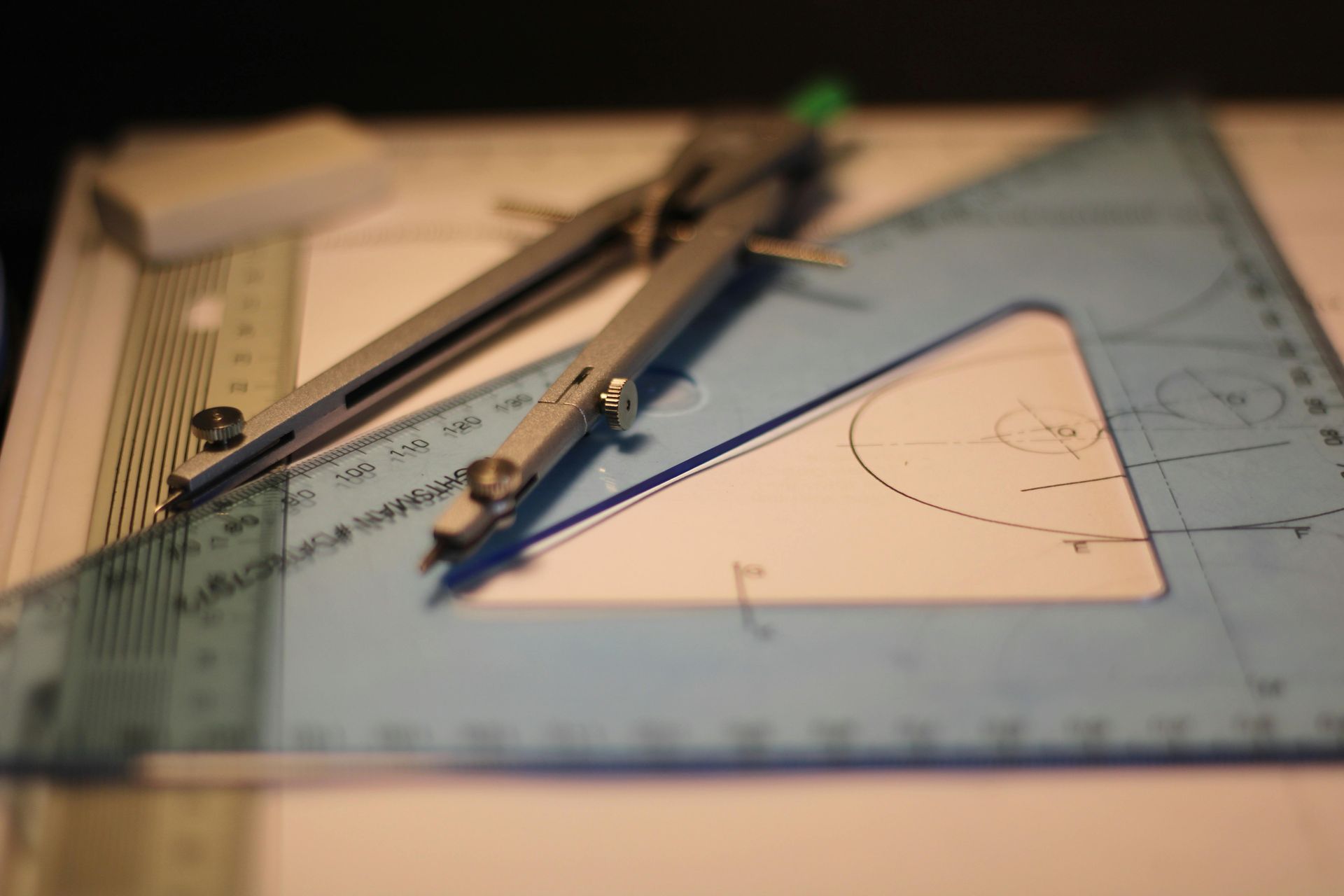 Compass and triangle on blueprint