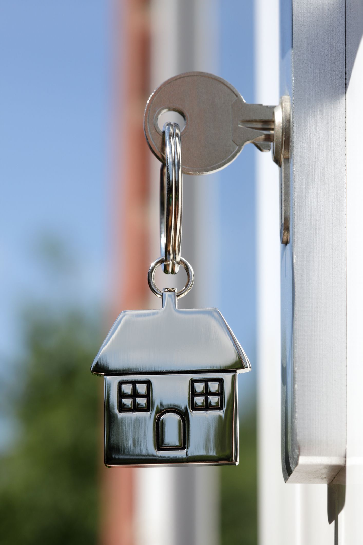 A key with a house keychain attached to it