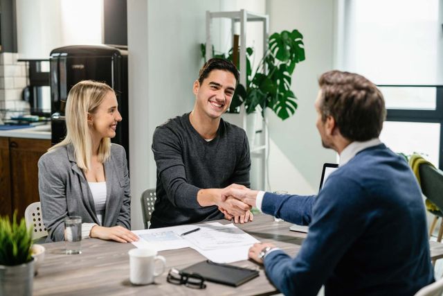 Happy Couple Shaking Hands With Their Real Estate Agent At Home — Placida, FL — Accounting 4 Profitability LLC