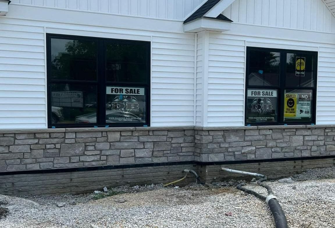 House with a Wooden Door and a Stone Wall – Moline, IL – QCFI Concrete & Masonry House with a Wooden Door and a Stone Wall – Moline, IL – QCFI Concrete & Masonry