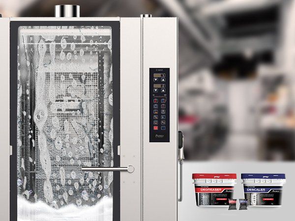 A stainless steel oven with a glass door is being cleaned in a kitchen.