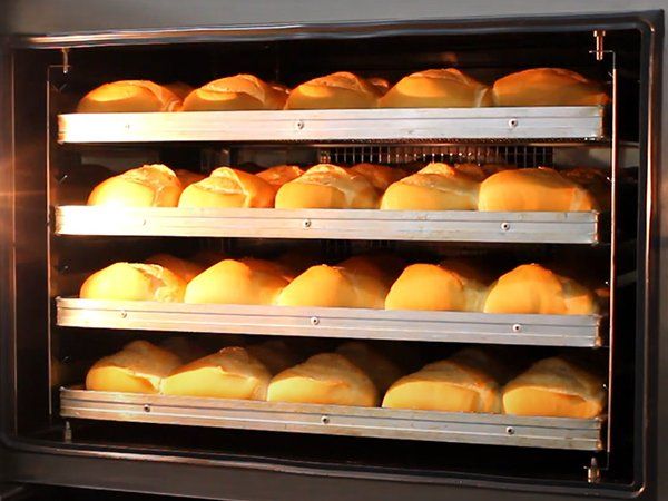A bunch of bread is baking in an oven.