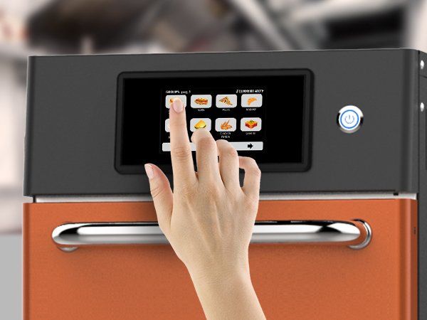 A hand is pressing a button on a touchscreen oven