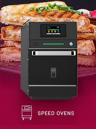 A picture of a speed oven with a stack of food in the background.