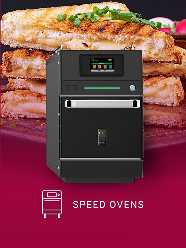 A picture of a speed oven with a stack of food in the background.