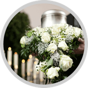 White rose floral arrangement with greenery and candles in a formal setting