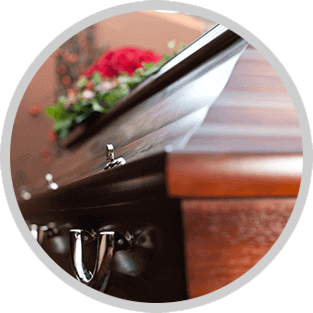 Open casket with white lining and pink flowers at a funeral viewing