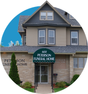 Peterson Funeral Home building with green awning and blue sky background