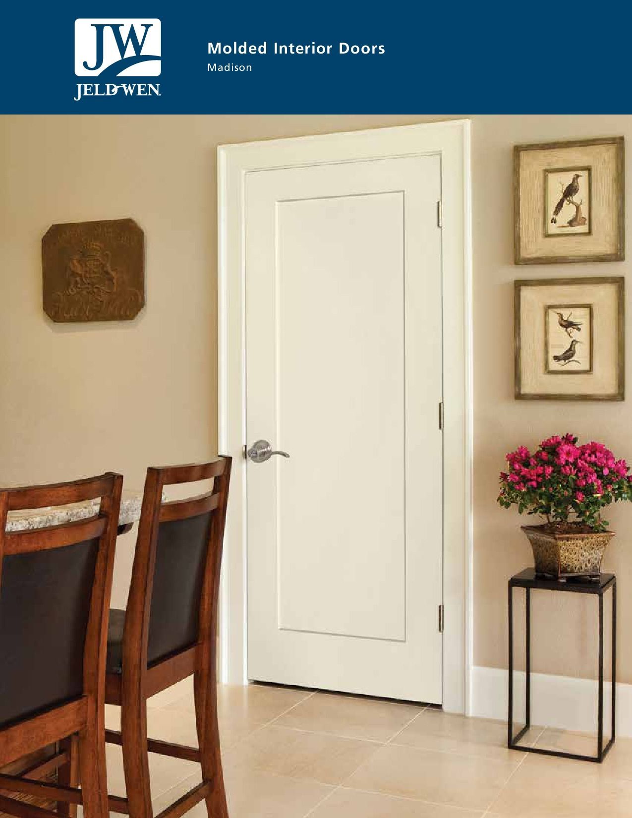 White interior door in a room with artwork, table, chairs, and flowers.