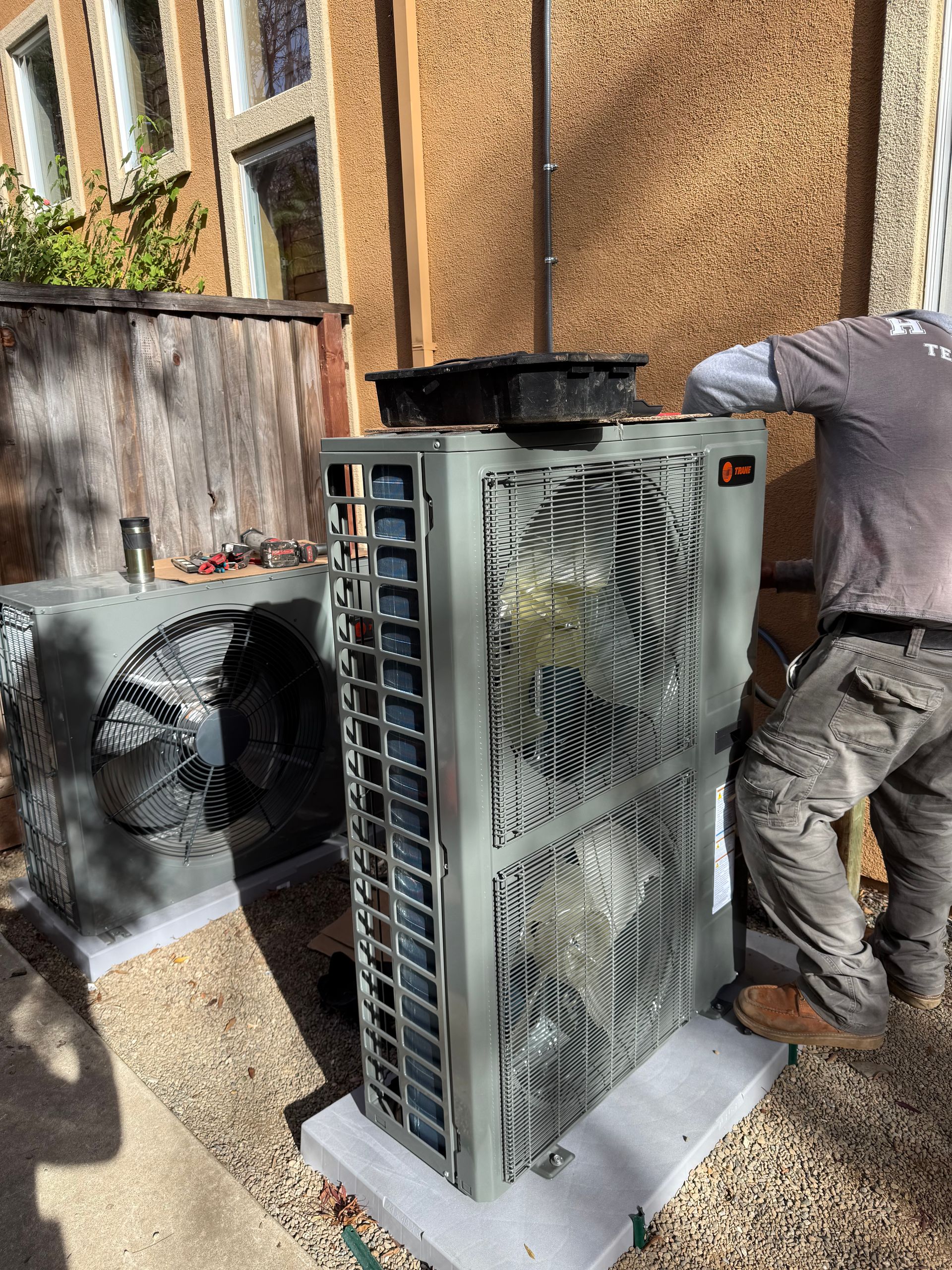 Person removing a dirty air filter from a furnace.