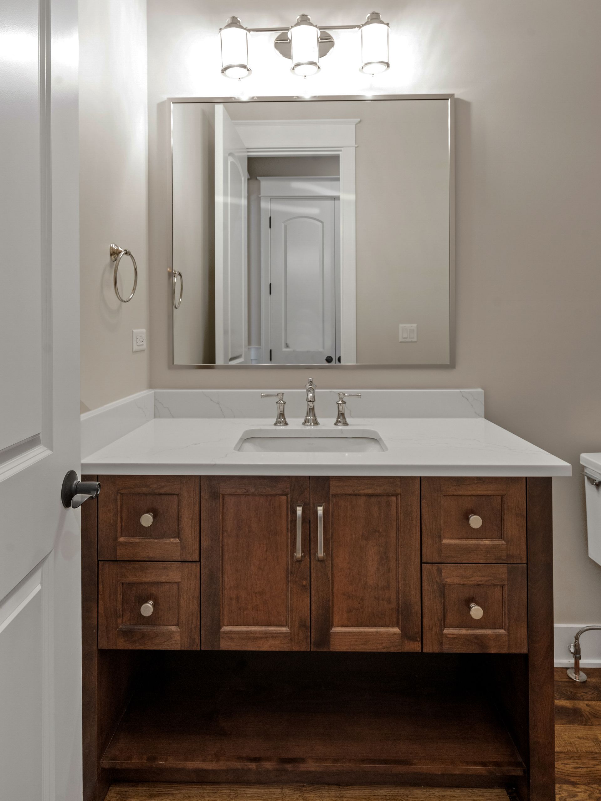 A bathroom with a sink a mirror and a toilet