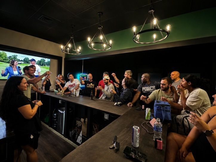 Golfers celebrating at simulator bay