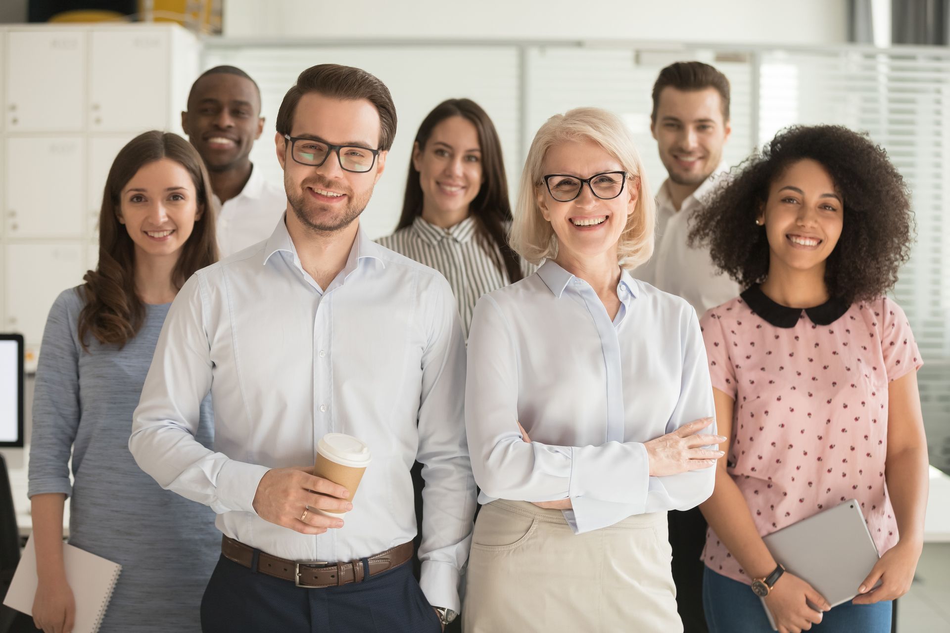 A group of people are posing for a picture in an office.