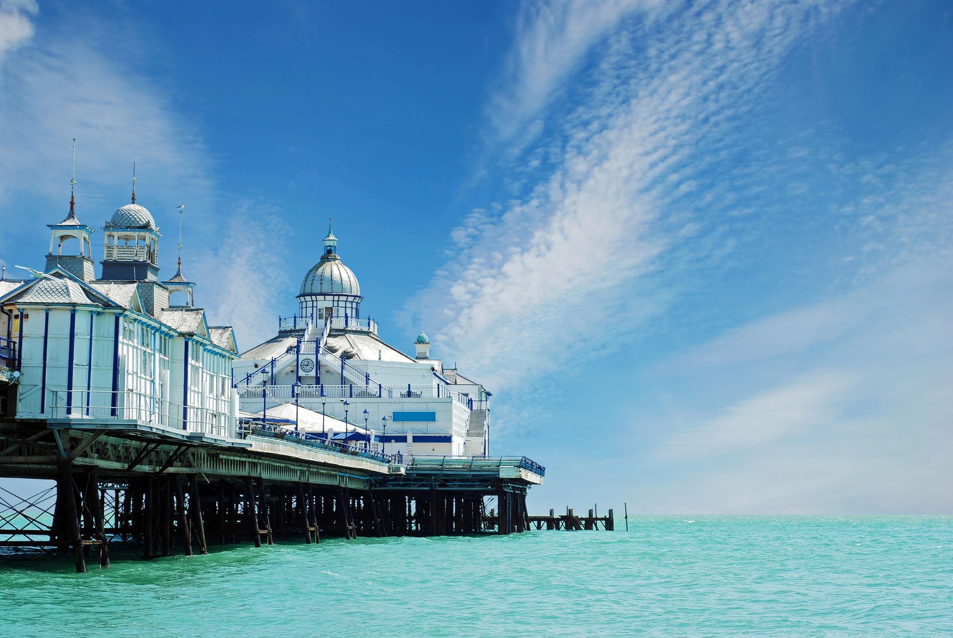 There is a pier in the middle of the ocean.