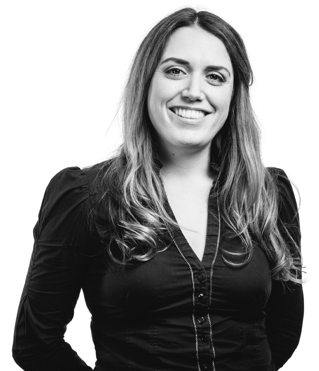 A woman in a black shirt is smiling in a black and white photo.