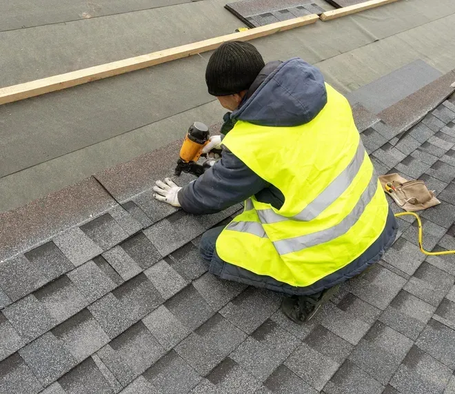 man with yellow uniform installing roof