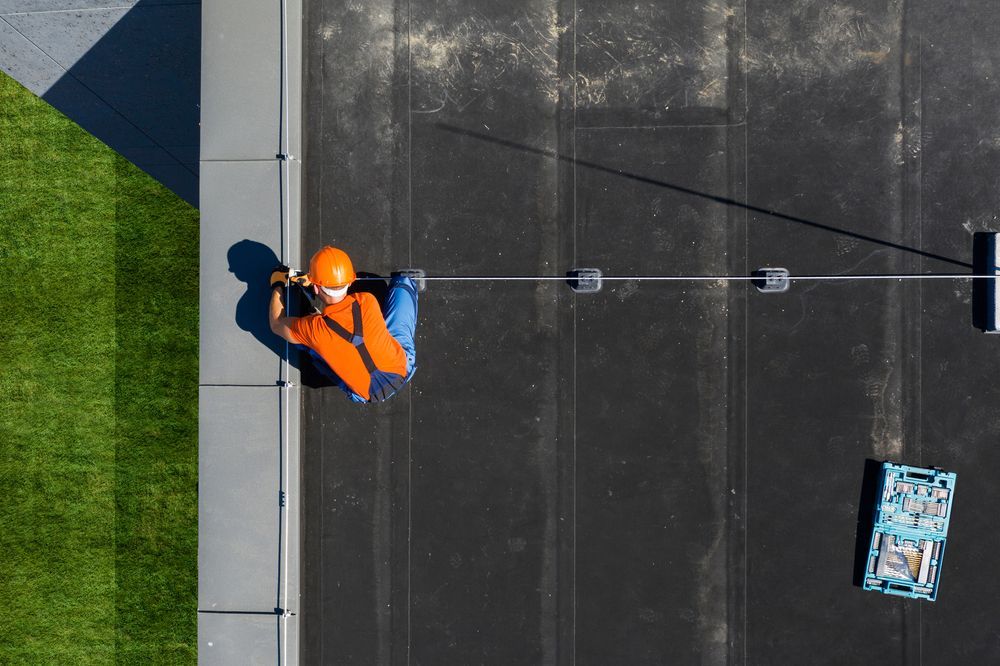 technician wearing orange uniform and hard hat